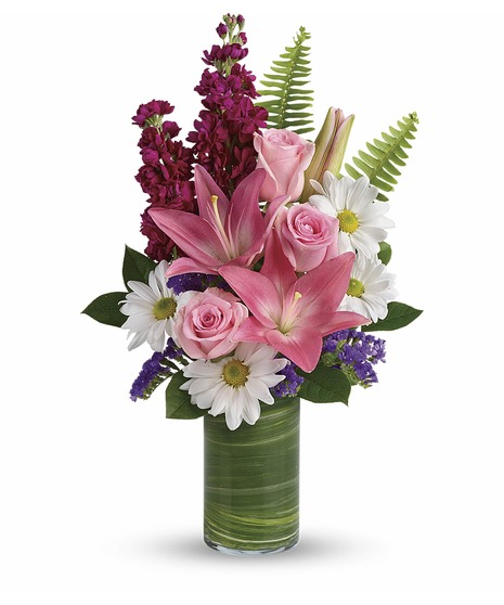 White daisies, pink roses and pink lilies with fuchsia stock in a modern cylinder vase