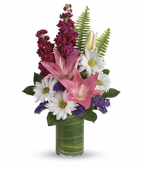 White daisies, pink roses and pink lilies with fuchsia stock in a modern cylinder vase